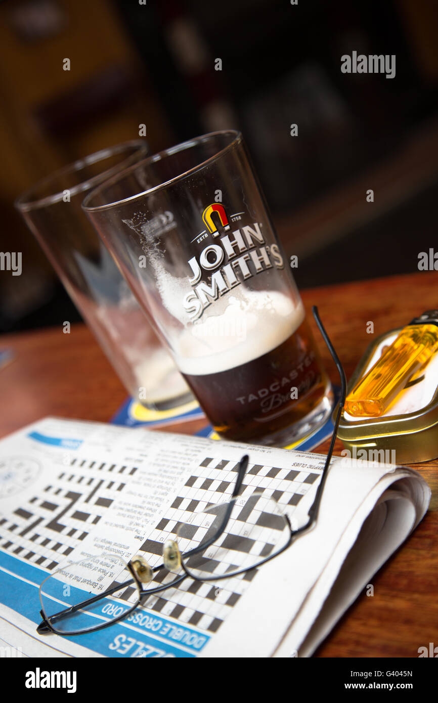 A Lunch Break View Of The Days Local Crossword Puzzle With The Remains Of A Pint Of Beer ale In An English Pub bar Stock Photo Alamy