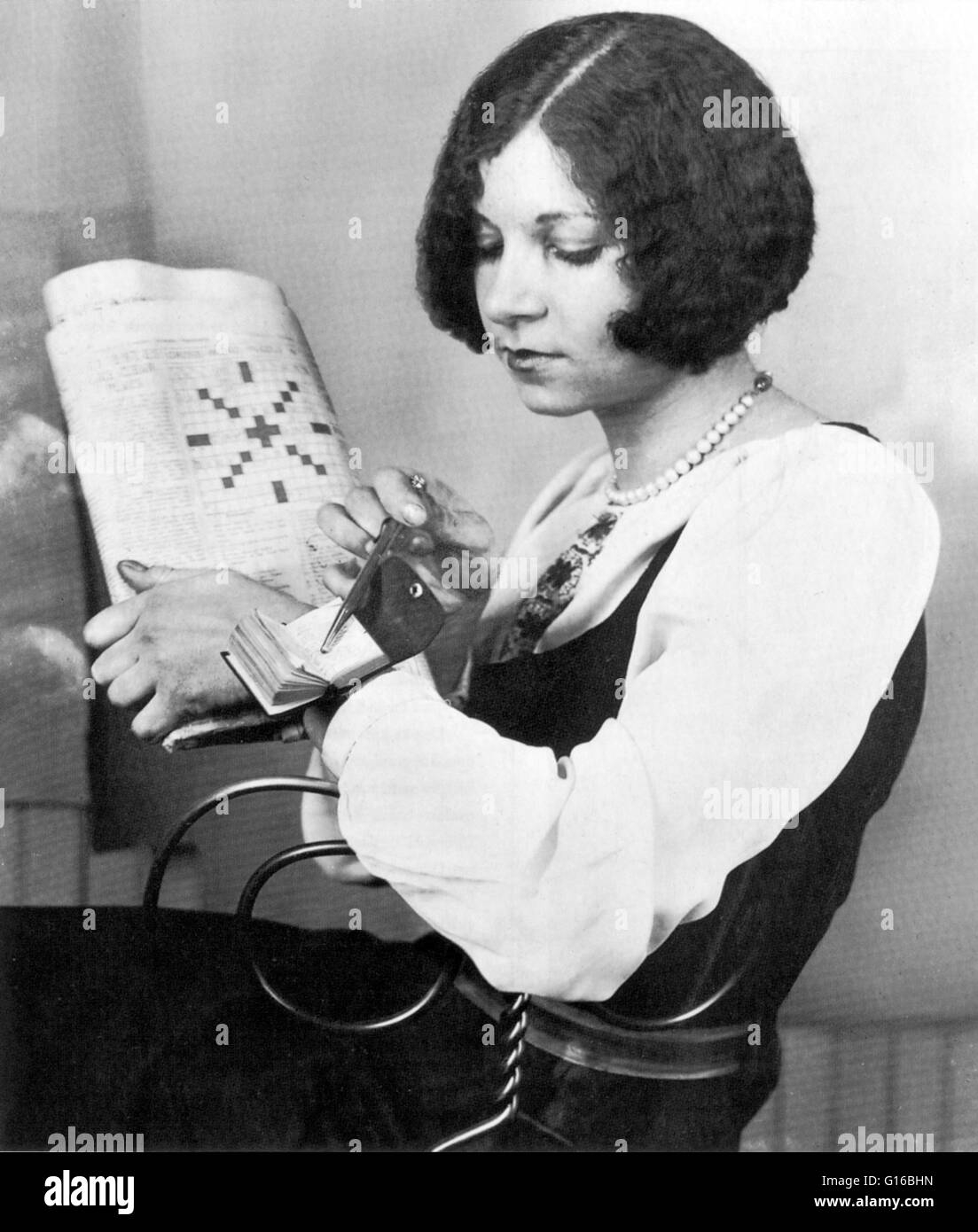 The 1920s Brought A Crossword Puzzle Fad To The United States This Young Woman Looks Up Egyptian Sun God In The World s Smallest Crossword Puzzle Dictionary Strapped To Her Wrist A Crossword