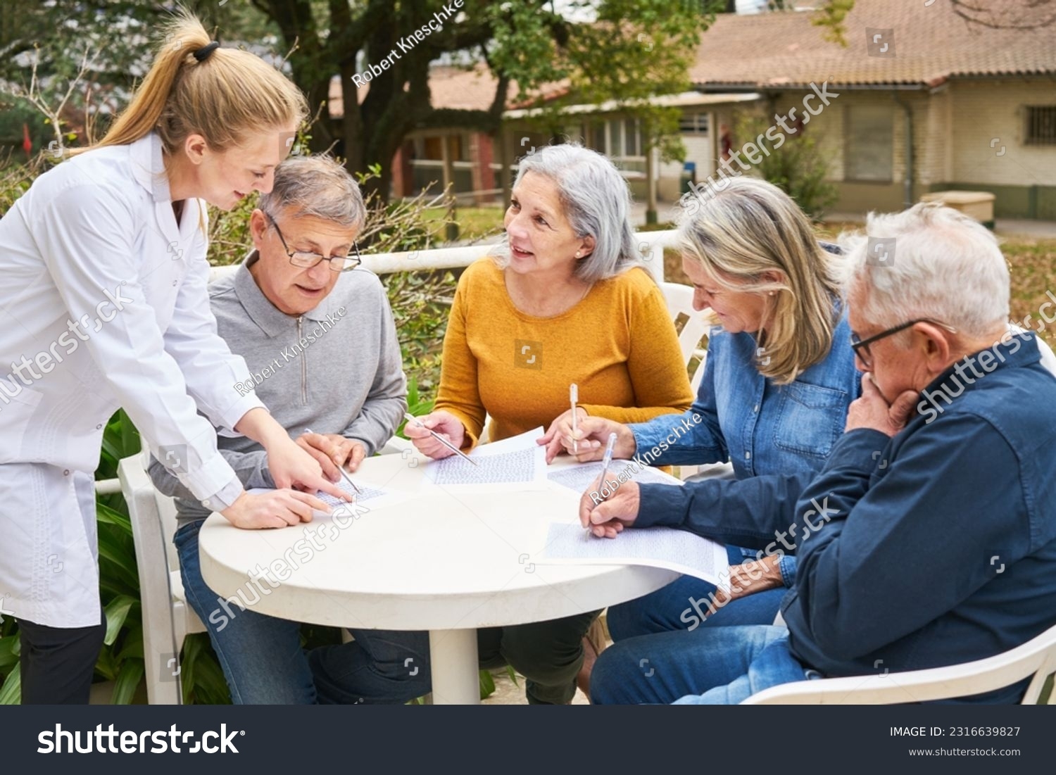 Group Senior Friends Solving Crossword Puzzle Stock Photo 2316639827 Shutterstock